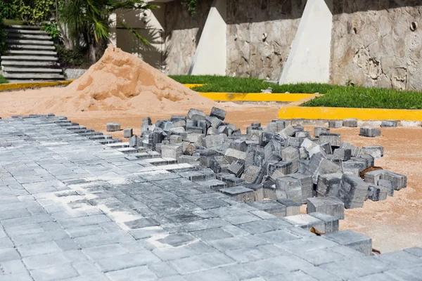 Process of building road with paving stone