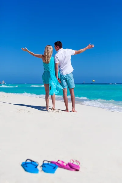 Beach flip-flops on romantic couple background