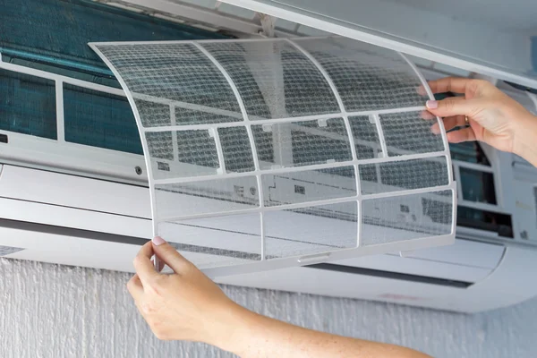 Dirty filter of air conditioner in female hands