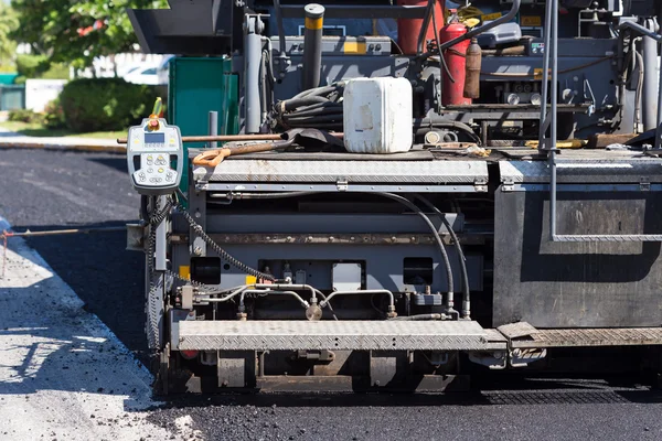 Pavement truck laying fresh asphalt