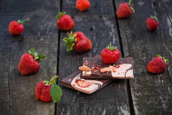 Handmade chocolate bar with dried strawberry slices and fresh be