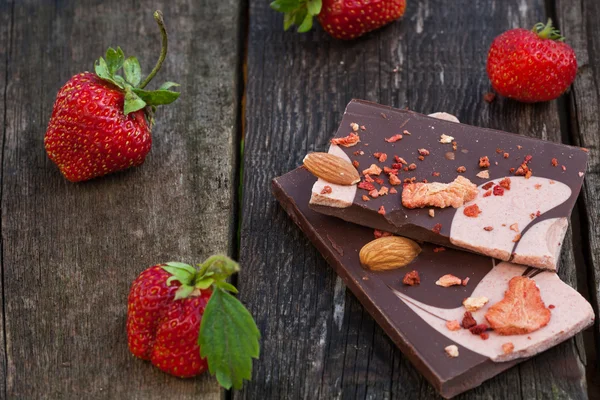 Handmade chocolate bar with dried strawberry slices and fresh be