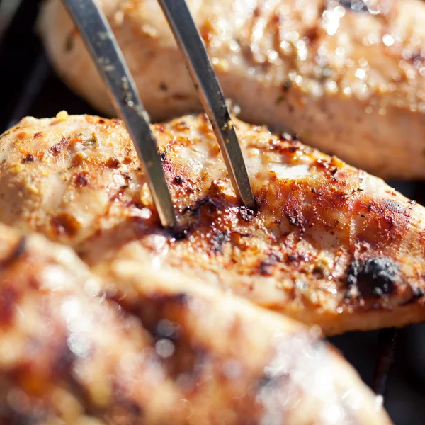 Grilled chicken breast on barbeque