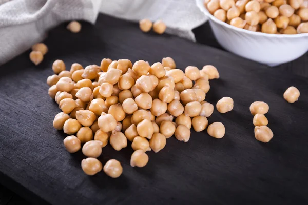 Chickpeas on wooden board