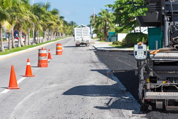 Pavement truck laying fresh asphalt