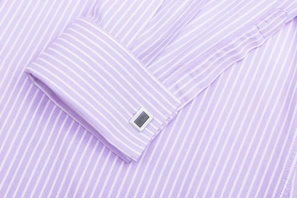 Sleeve of a striped pink shirt with a cuff link