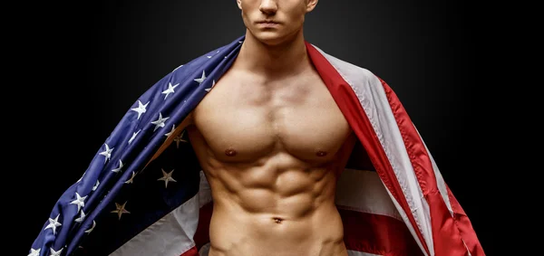 Handsome young mans torso covered with american flag