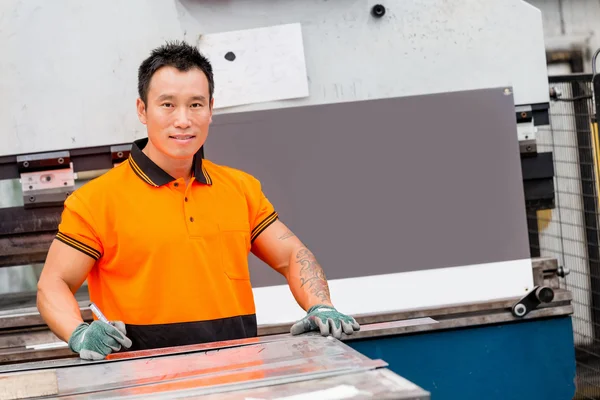 Asian worker in production plant on the factory floor