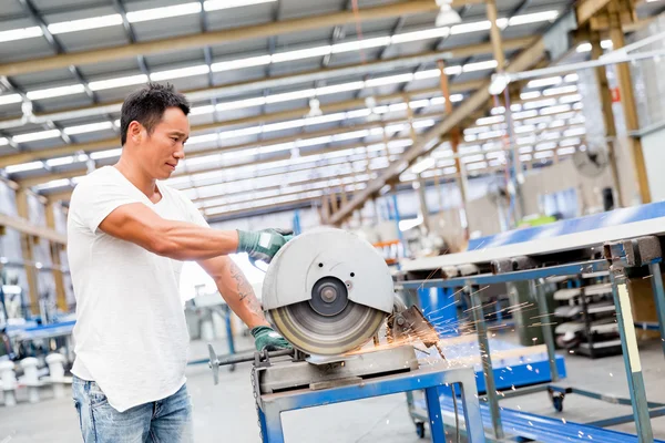 Asian worker in production plant on the factory floor