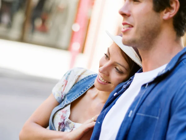 Happy young couple walking in city