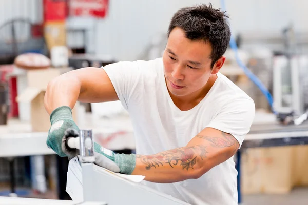 Asian worker in production plant on the factory floor