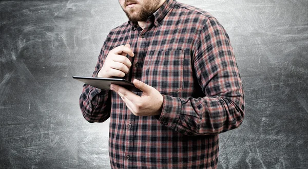 Hipster guy with tablet device . Mixed media