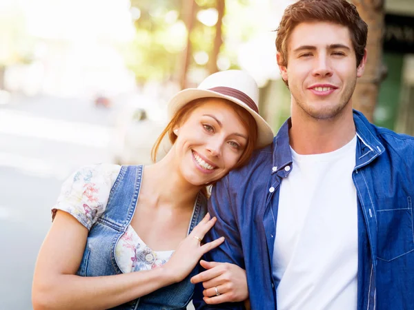 Happy young couple walking in city