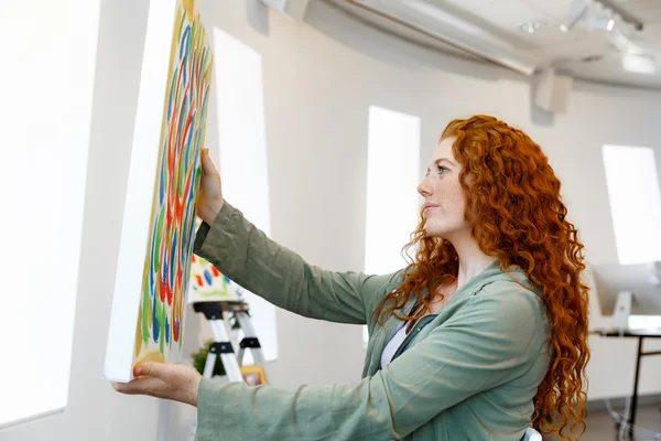 Young female artist with her picture