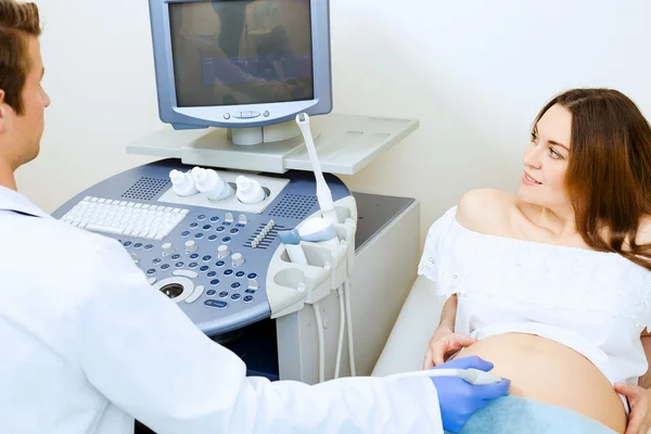Pregnant woman examined by doctor