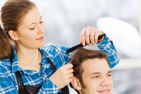 Young man and woman hairdresser