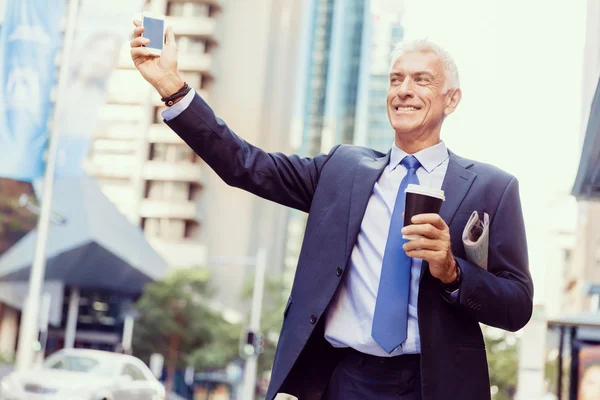 Businessman catching taxi in city