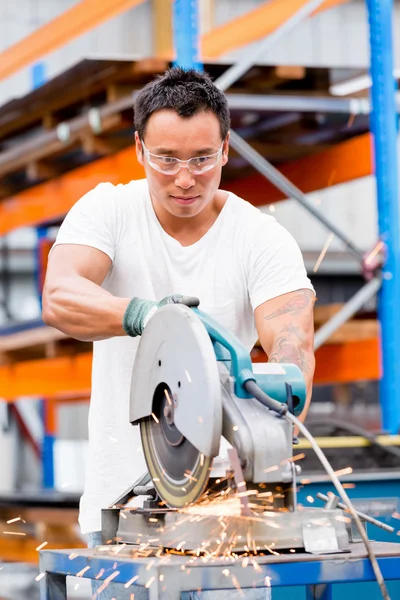 Asian worker in production plant on the factory floor