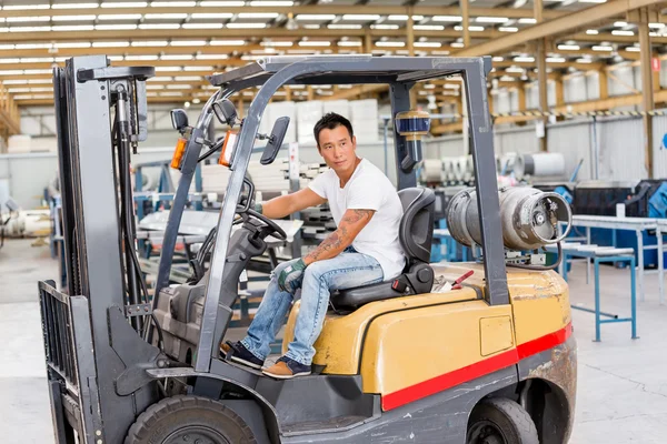 Asian worker in production plant on the factory floor