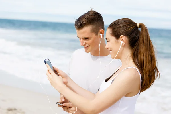 Couple of runners with mobile smart phones outdoors