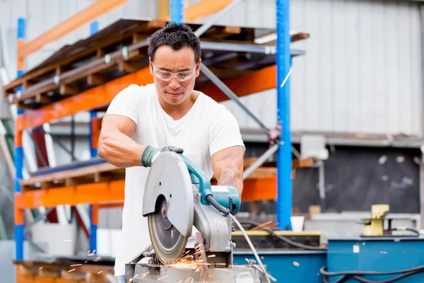 Asian worker in production plant on the factory floor