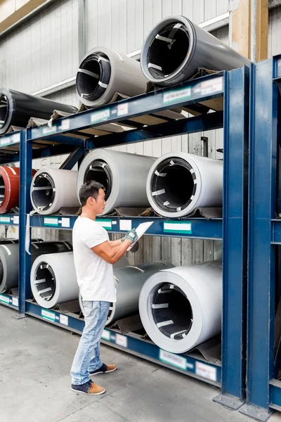 Asian worker in production plant on the factory floor