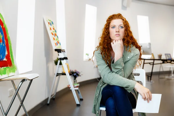 Young female artist with her picture