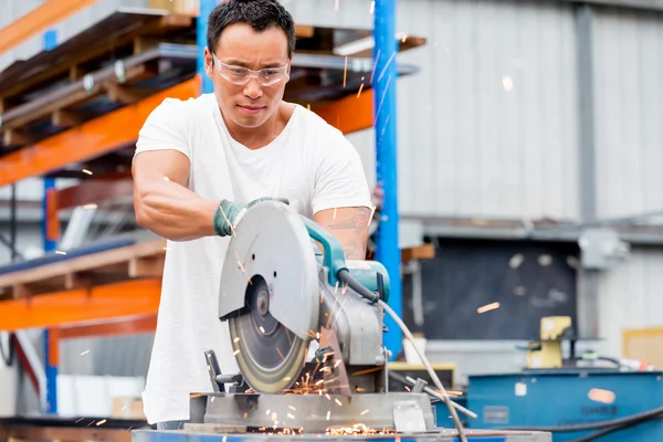 Asian worker in production plant on the factory floor