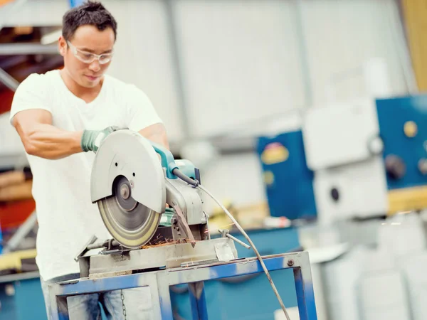 Asian worker in production plant on the factory floor