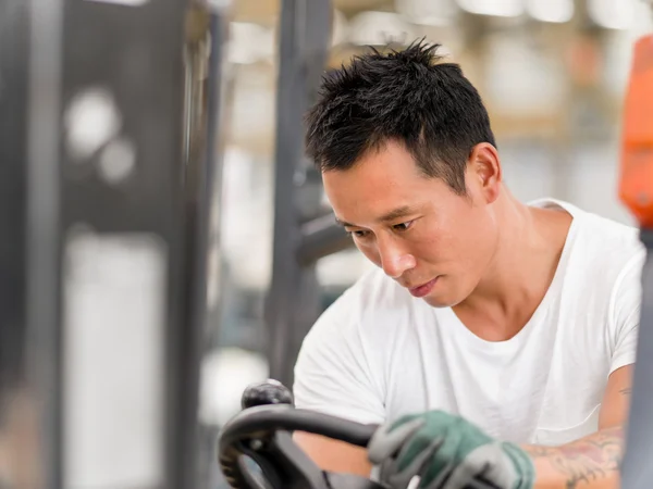 Asian worker in production plant on the factory floor