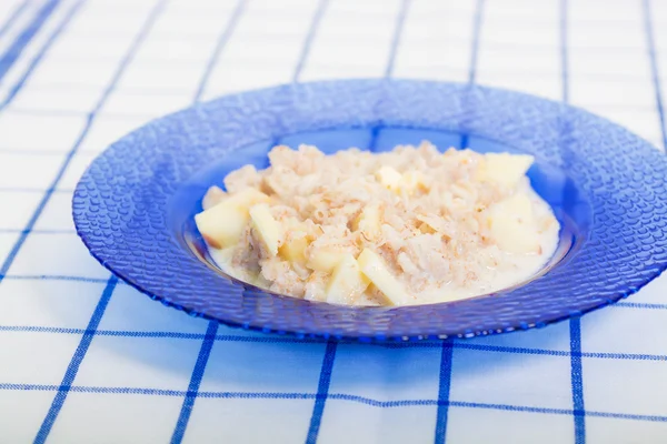 Hot  porridge for breakfast on blue plate