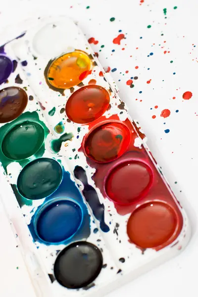 Palette of children\'s watercolor paint on white