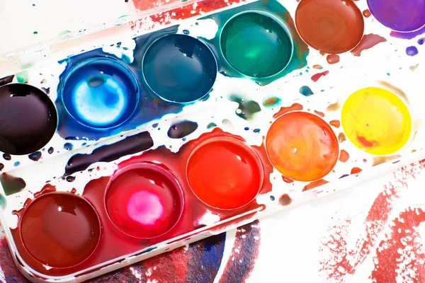 Palette of children\'s watercolor paint on white