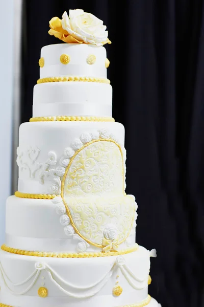Wedding cake decorated with yellow sugar pattern