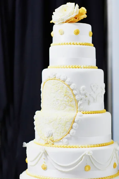 Wedding cake decorated with yellow sugar pattern