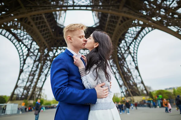 Romantic couple kissing just the Eiffel tower