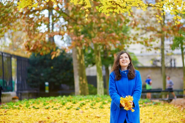 Beautiful young tourist in Paris on a fall day