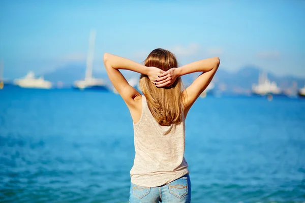 Young girl enjoying her vacation by the sea