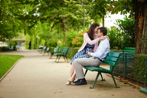 Dating couple on a bench in a Parisian park