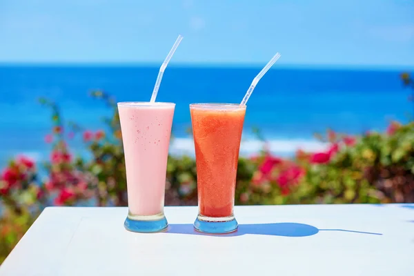 Two fresh juices or smoothies on a tropical resort