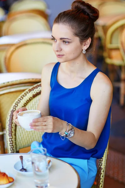 Beautiful young Parisian woman in cafe
