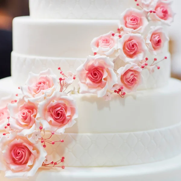 White wedding cake decorated with flowers