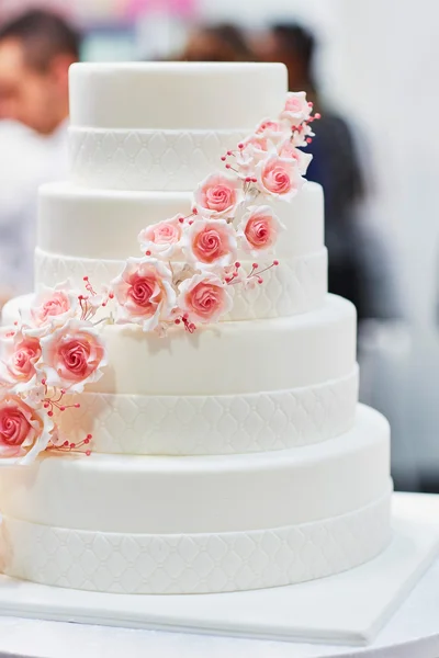 White wedding cake decorated with flowers