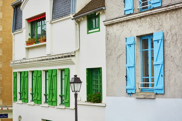 Parisian buildings with green and blue window shutters