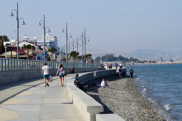 LARNACA, CYPRUS - APRIL 7, 2016: view of Larnaca seafront with palm trees , pedestrians and beach on April 7 in Larnaca, Cyprus.Larnaca -  is a city on  southern coast  and capital of eponymous district.