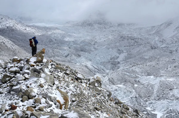 Mountaineer standing on hillside waste near Khumbu Icefall - one of the most dangerous stages of the South Col route to Everest's summit,Nepal,Asia