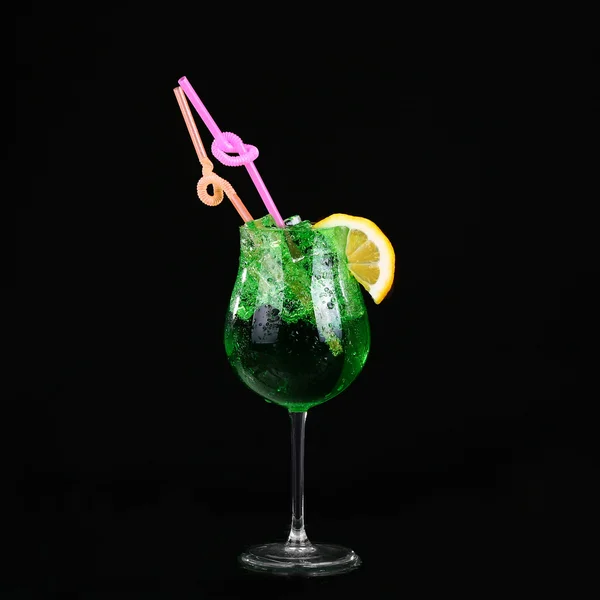 Piggelin Drink, consisting of vodka, melon liqueur and lemon-lime soda. on black background