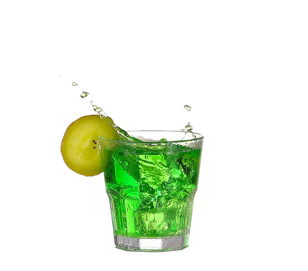 Green alcohol cocktail with splash and green lime isolated on wh