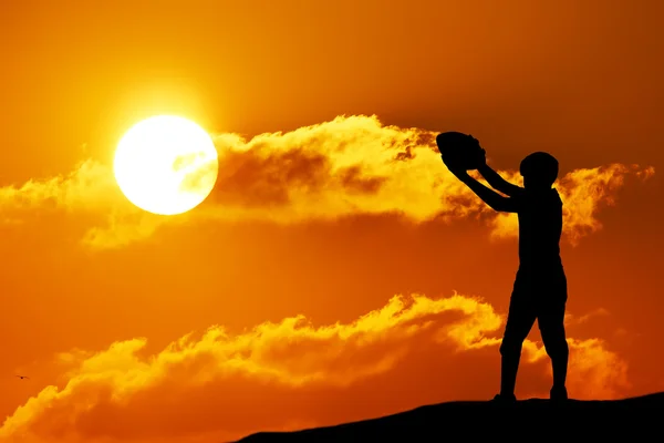 Silhouette of soccer man playing with the ball