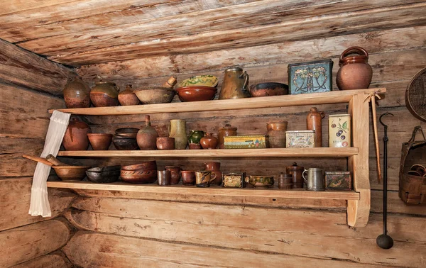 Vintage wooden shelf with old ceramic tableware